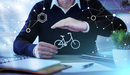 Insurer protecting a bicycle with his hand; light-effectの写真素材