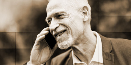 Mature man talking on mobile phone outdoors, geometric pattern
