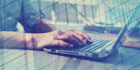 Female hands using a laptop in office, double exposure, geometric patternの写真素材