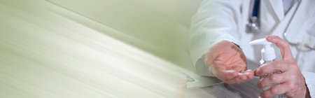 Doctor pressing on sanitizer alcohol gel bottle; prevention of virus and bacteria infection; panoramic bannerの写真素材