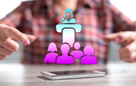 Smartphone with conference concept between hands of a woman in backgroundの写真素材