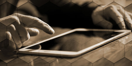 Man using his tablet at home, hard light and flare effect, geometric pattern