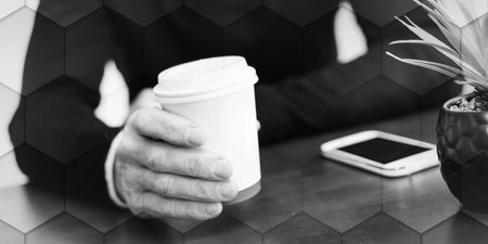 Man having coffee break at home, geometric pattern