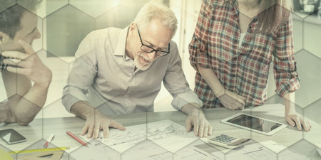 Architects working on plans at office, light effect, geometric pattern