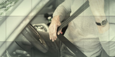 Man fastening seat belt in car, geometric patternの写真素材