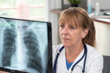 Female doctor looking at x-ray in medical office