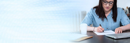 Businesswoman checking document in office; panoramic banner