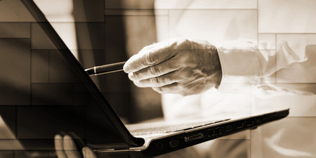 Standing businessman working on laptop, geometric patternの写真素材