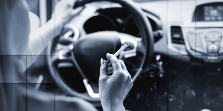 Woman smoking a cigarette while driving, geometric patternの写真素材