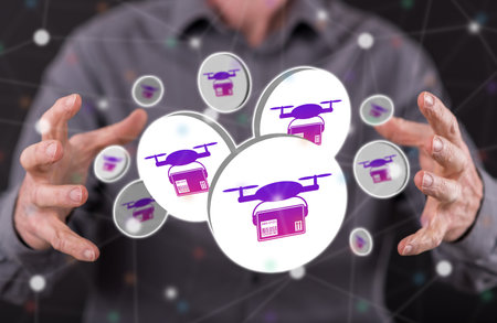 Drone delivery concept between hands of a man in backgroundの写真素材