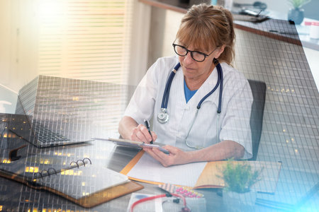 Female doctor taking notes on clipboard in medical office; multiple exposureの写真素材