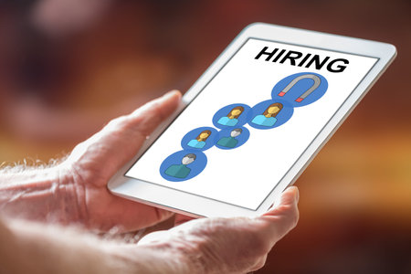 Man holding a tablet showing hiring conceptの写真素材