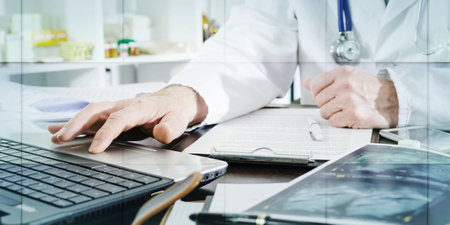 Doctor using a laptop in medical office, geometric pattern