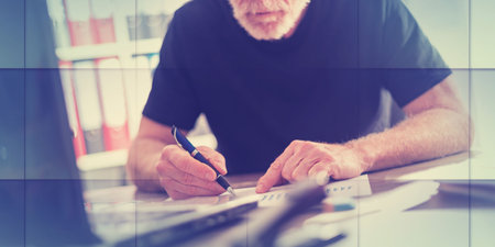 Senior man working in office, geometric patternの写真素材