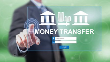 Man touching a money transfer concept on a touch screen with his fingersの写真素材