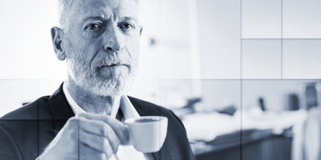 Portrait of senior businessman holding a cup of coffee, geometric patternの写真素材