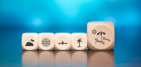 Wooden blocks with symbol of vacation concept on blue backgroundの写真素材