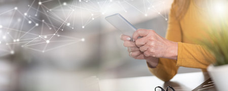 Woman holding and using her mobile phone; panoramic banner