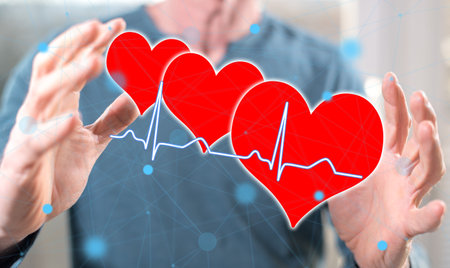 A health concept between hands of a man in backgroundの写真素材