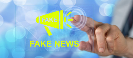 Man touching a fake news concept on a touch screen with his fingerの写真素材