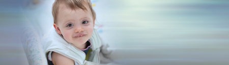 Portrait of baby girl sitting in her bed after sleeping; panoramic bannerの写真素材