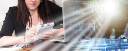 Young woman taking notes on notepad; multiple exposureの写真素材