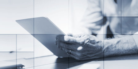 Businessman using his tablet at officek, geometric pattern