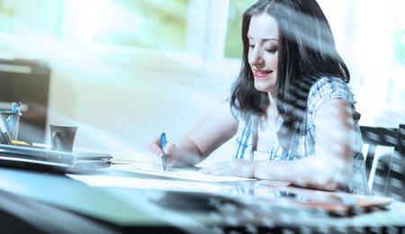 Young businesswoman working on documents at office, light effect; light-effect