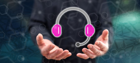 Call center concept above the hands of a man in backgroundの写真素材