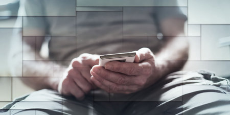 Man sitting using his smartphone, geometric patternの写真素材