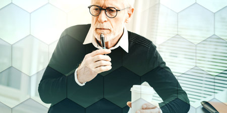 Portrait of thoughtful senior businessman at office, geometric patternの写真素材