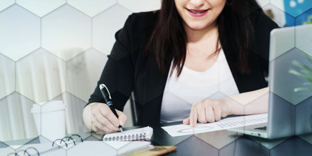 Businesswoman analyzing marketing data and taking notes, geometric patternの写真素材