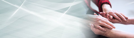 Hands of young woman holding the hands of an elderly person; panoramic banner