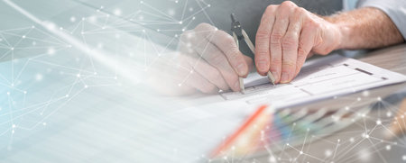 Architect working on a project and using a compass; panoramic banner