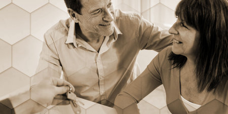 Happy senior couple getting house keys from realtor, geometric pattern