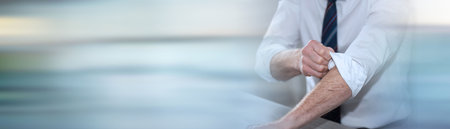 Businessman rolling up his sleeves; concept of motivation; panoramic bannerの写真素材