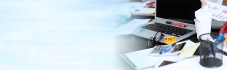Messy and cluttered office desk; panoramic banner