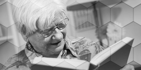 Old woman reading a book at home, geometric patternの写真素材