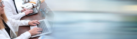 Businesspeople working together in office; panoramic banner