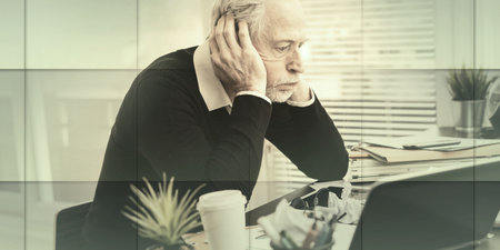 Overworked businessman sitting at a messy desk in office, geometric pattern