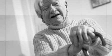 old woman sitting with her hands on a cane, geometric pattern