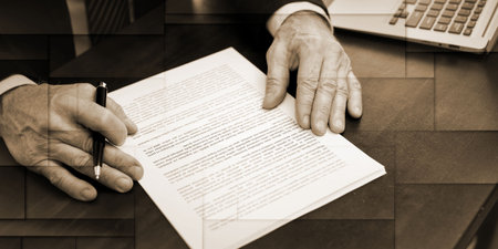 Businessman reading and checking document in office (lorem ipsum text used), geometric pattern