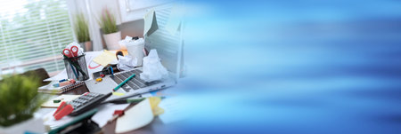 Messy and cluttered office desk; panoramic bannerの写真素材