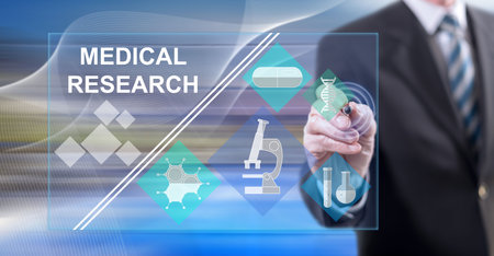 Man touching a medical research concept on a touch screen with a stylus penの写真素材