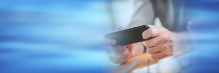 Male hands using mobile phone; panoramic bannerの写真素材