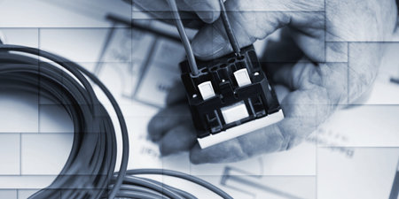 Electrician hands connecting a wire into a power socket, geometric patternの写真素材