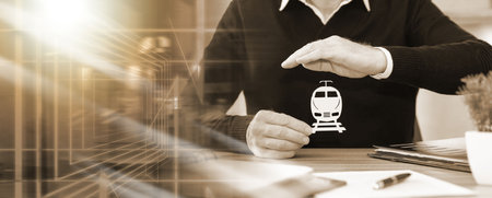 Insurer protecting a train with his hand; multiple exposureの写真素材