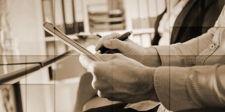 Businessman taking notes during a meeting, geometric patternの写真素材