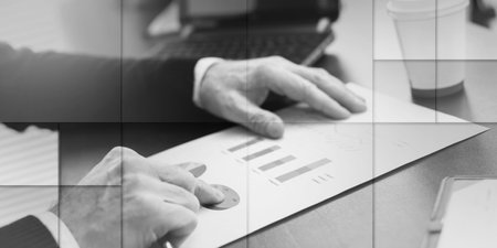 Businessman analyzing marketing graphs at office, geometric patternの写真素材