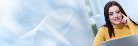Portrait of young businesswoman working from home; panoramic bannerの写真素材